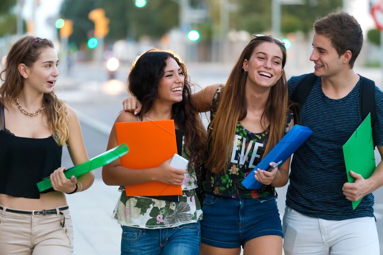 A group of friends talking in the street after class